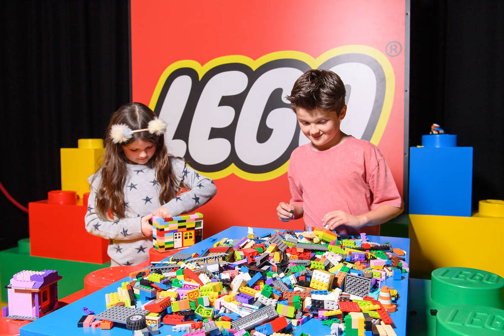 two children playing with LEGO