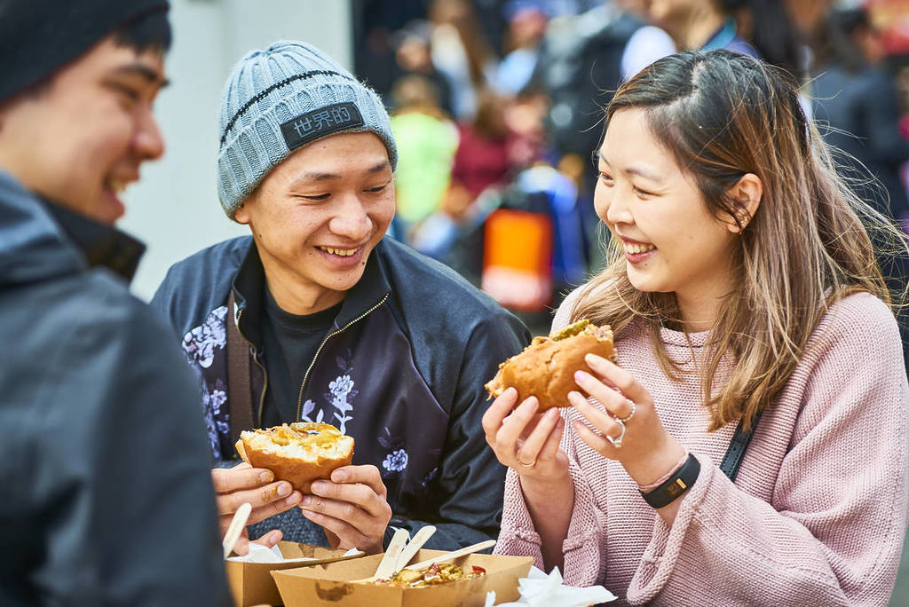 people smiling and eating burgers