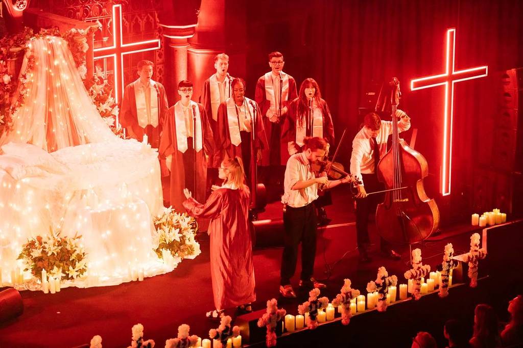 a choir and live musicians performing for a live screening of Baz Luhrmann's Romeo + Juliet