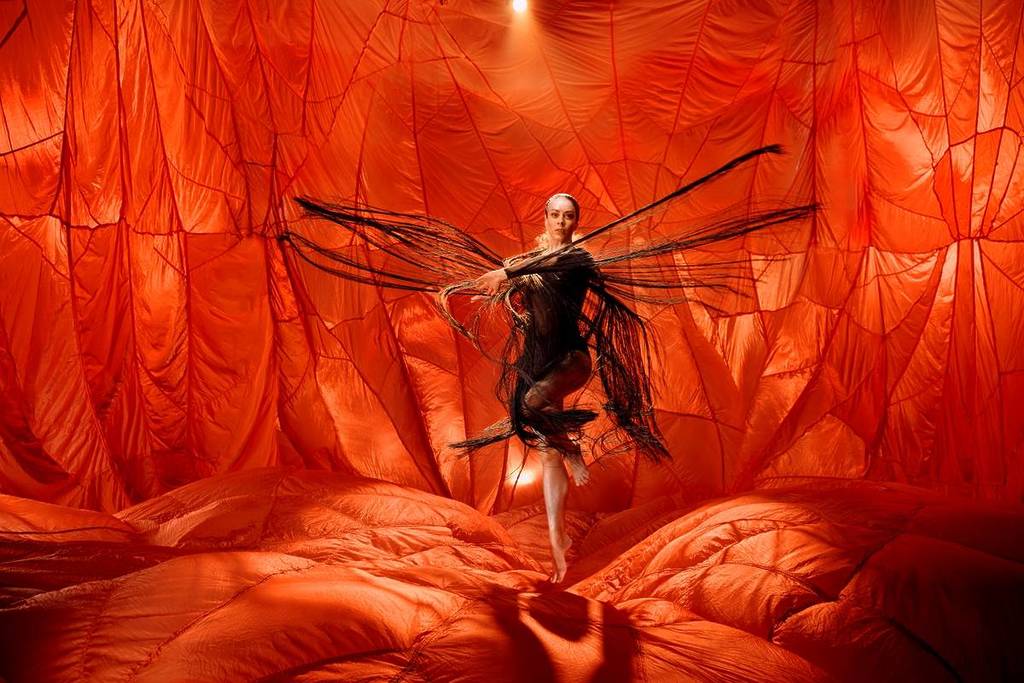 dancer from Bangarra Dance Theatre in a room surrounded by red cloth