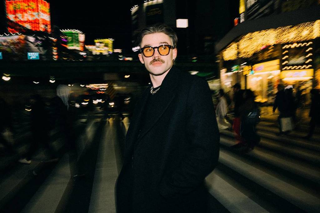 Dom Dolla at night on a pedestrian crossing