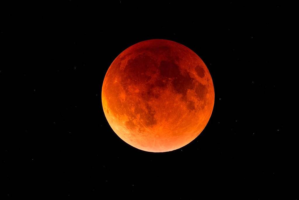 a full moon, with a red colour, depicting the blood moon during a lunar eclipse