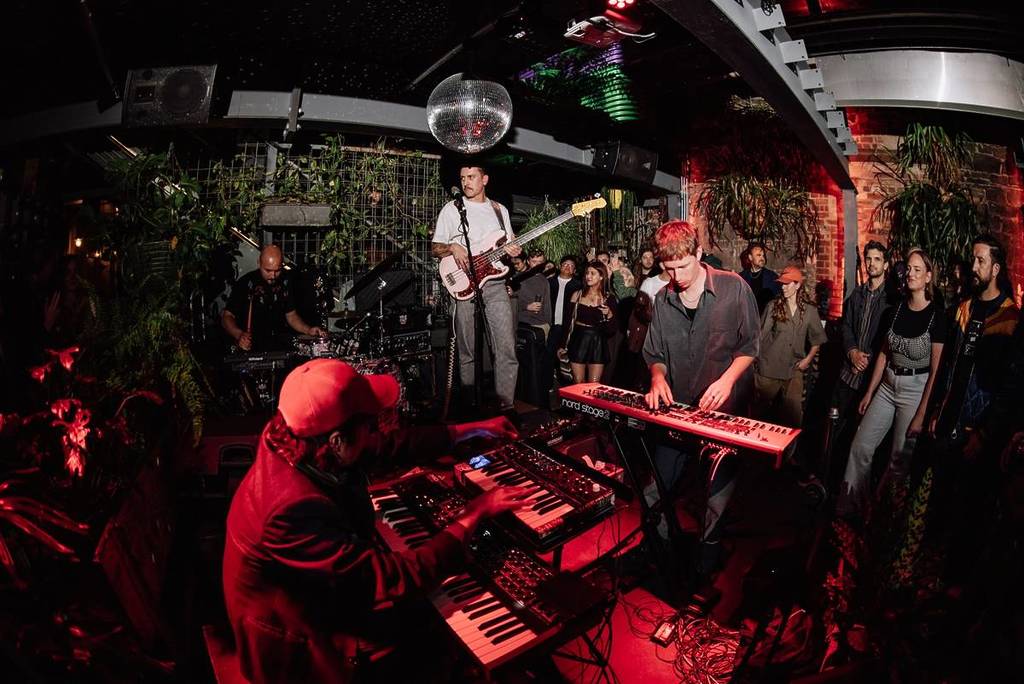 musicians on keyboards, a guitar etc. playing in an intimate gig with close onlookers during Night Crawl at the Melbourne International Jazz Festival
