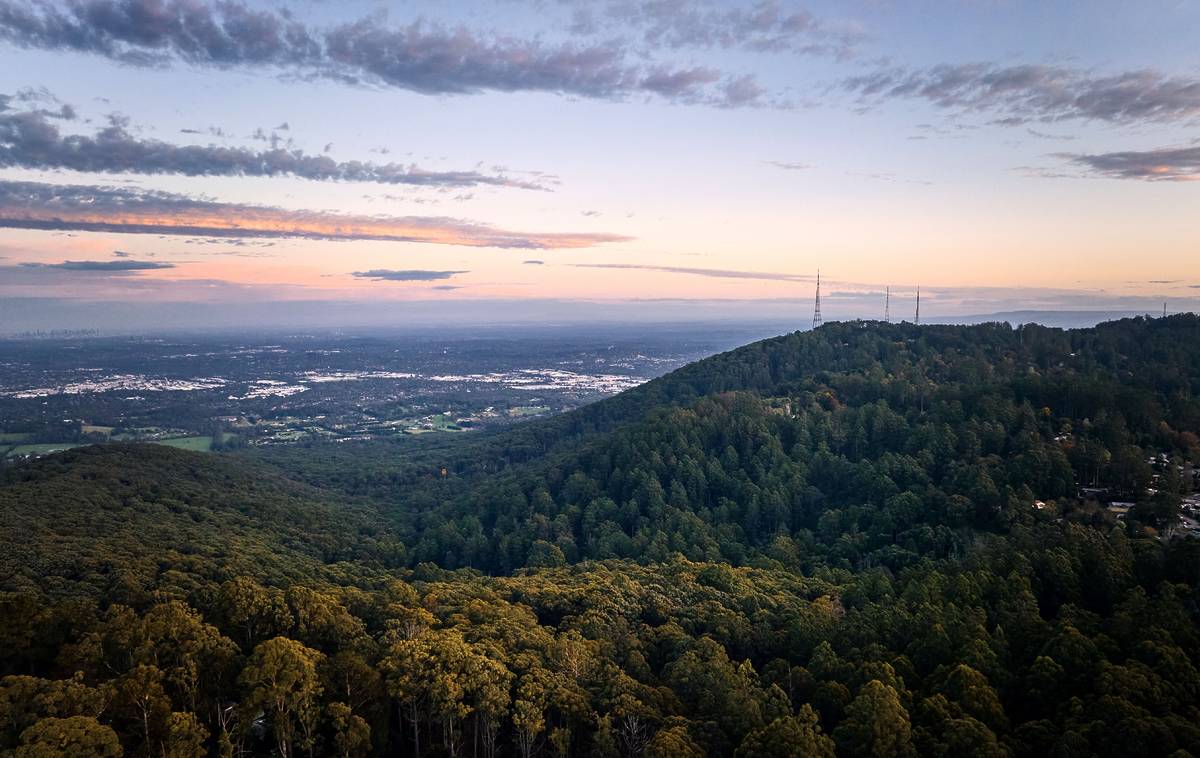 A stunning landscape view of rolling hills and a lush forest, with scenic vistas that showcase the natural beauty of Olinda and surroundings in spring