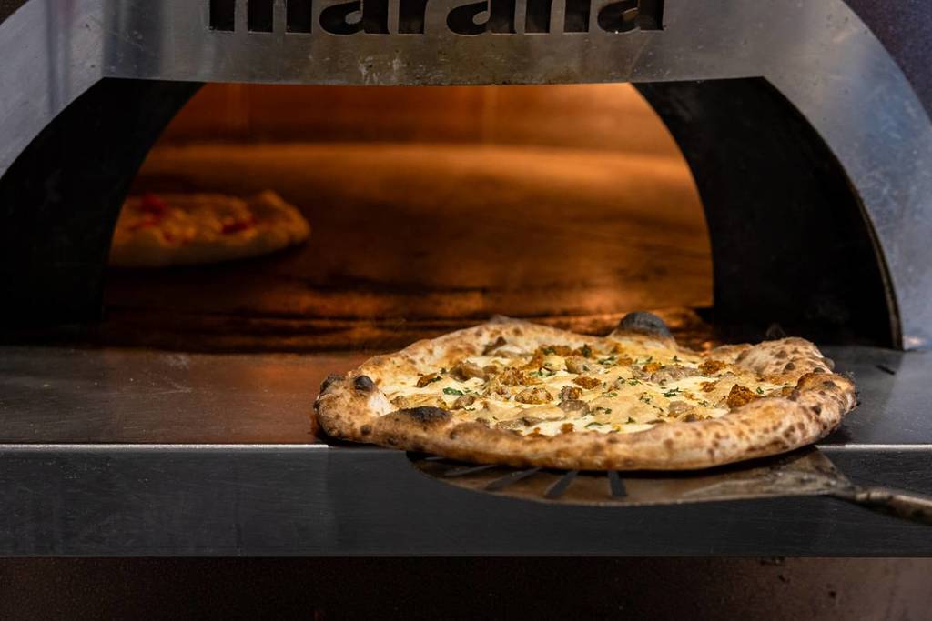 pizza coming out of oven at Shop225