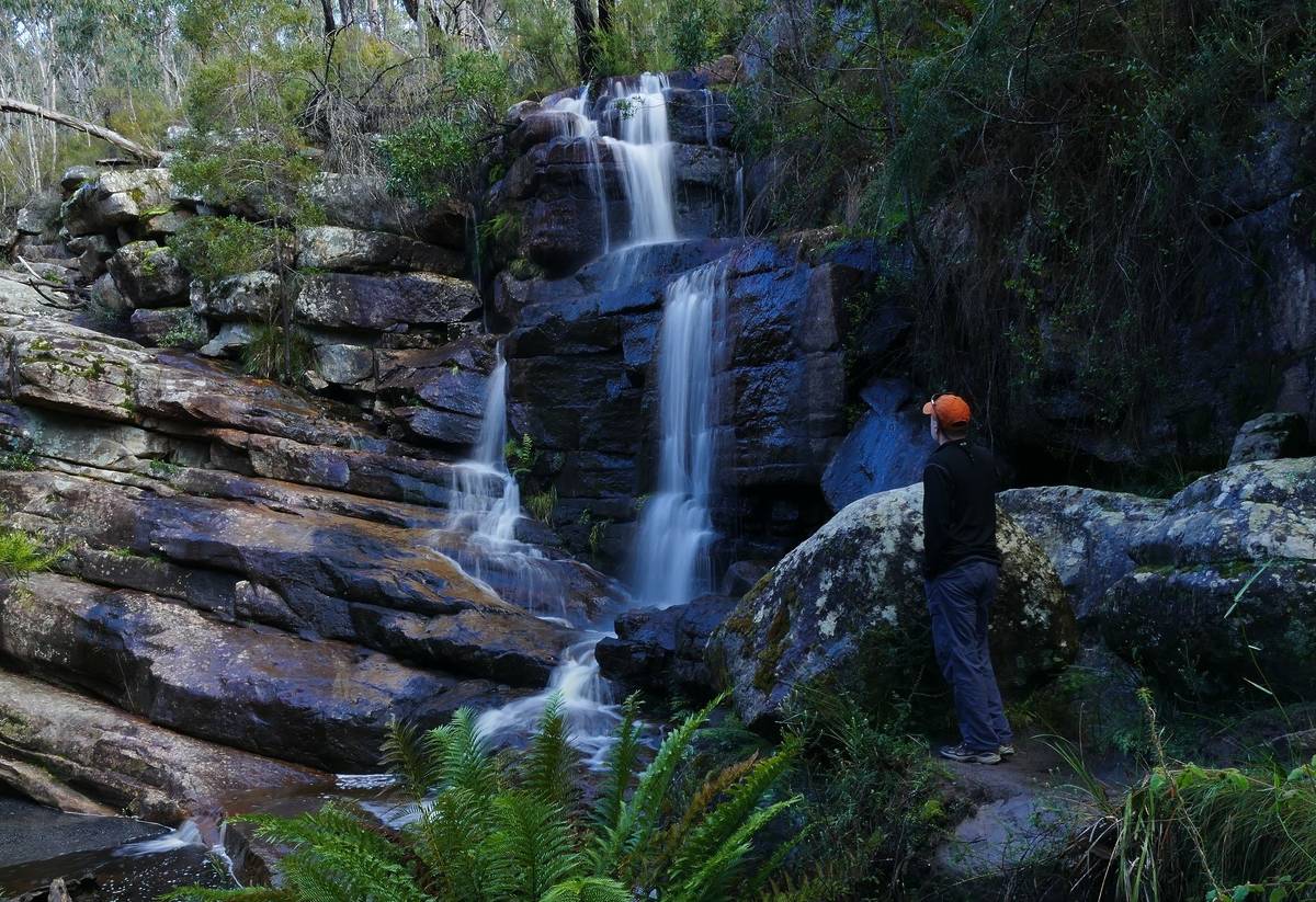 Splitter Falls in the Grampians National Park, with cascading water surrounded by lush greenery and rugged rocks