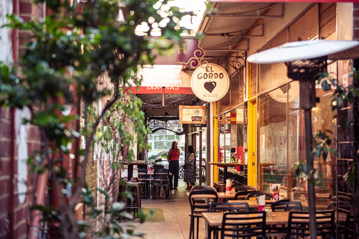 Charming laneway in Bendigo with colourful signage and outdoor seating