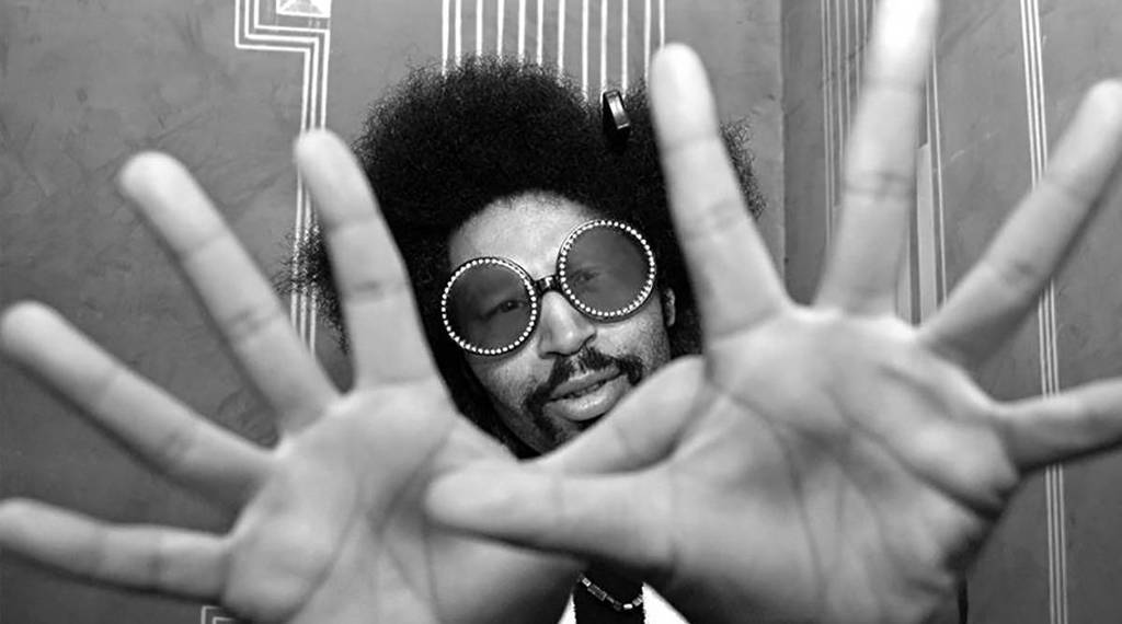 Moodymann looking at the camera with his palms up