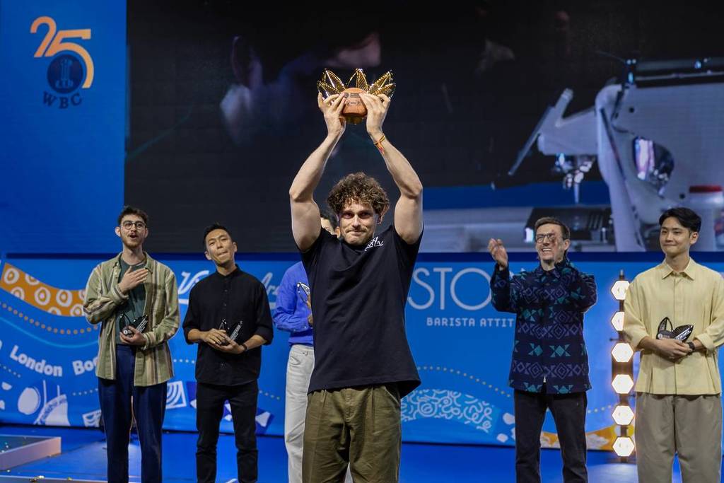 Jack Simpson holding up the trophy at the World Barista Championship