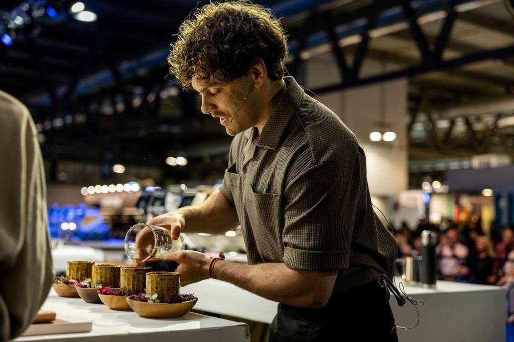 Jack Simpson pouring coffee at semi finals of World Barista Championships