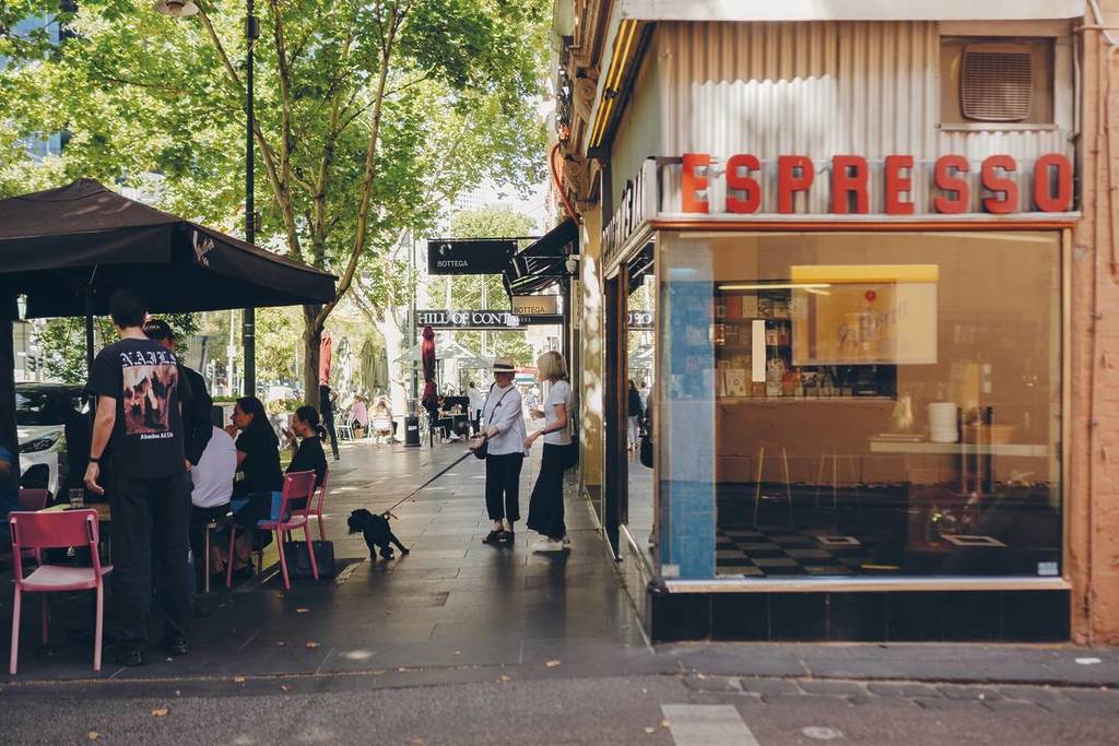 people walking and dining in front of Pellegrini's Espresso Bar in Melbourne, which received a shout-out from Lonely Planet