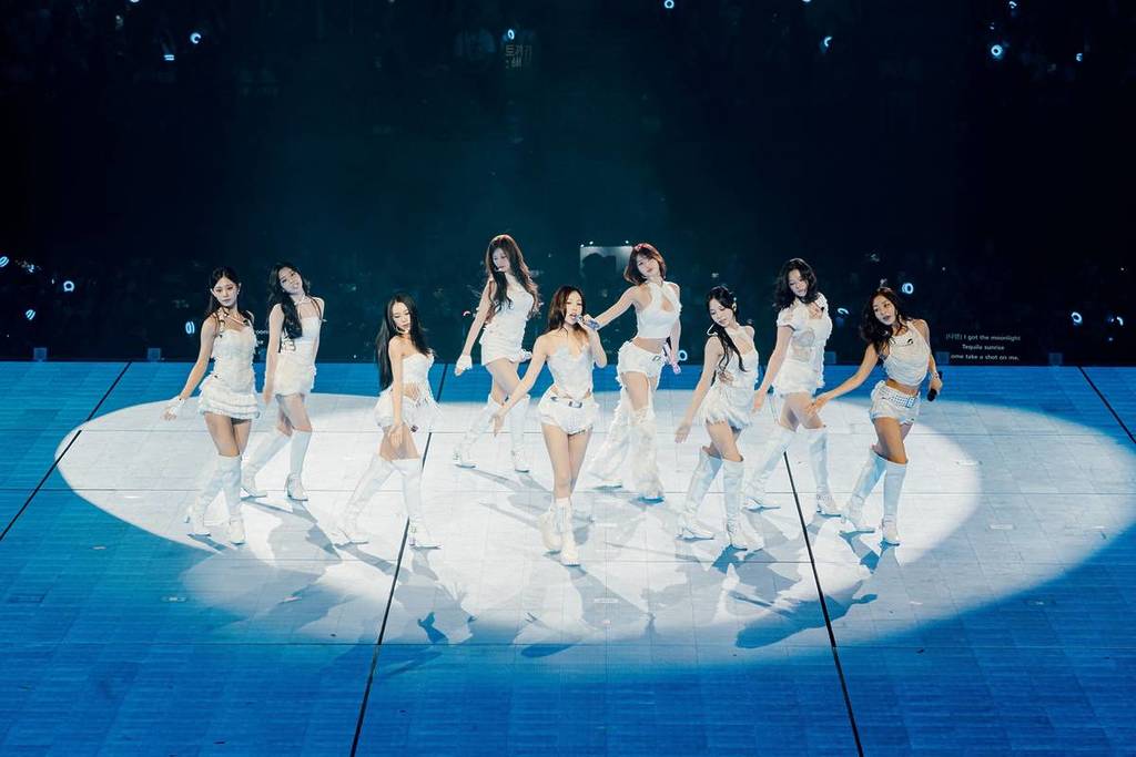 TWICE members performing on stage