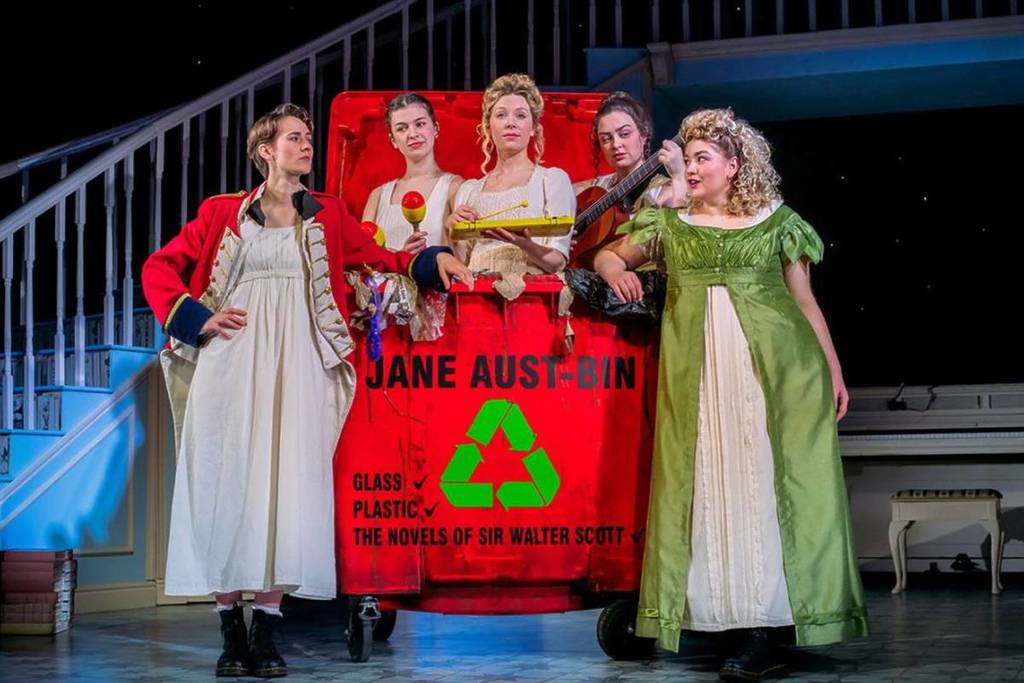 cast of Pride and Prejudice sort of gathered around a Jane Aust-bin