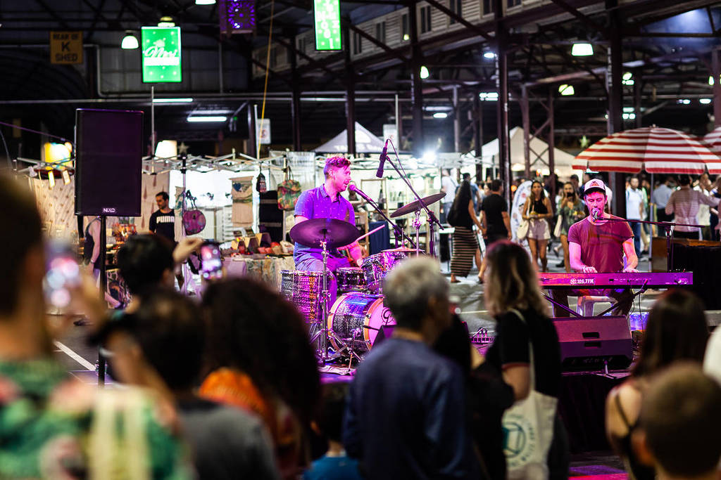 people watching a drummer at Queen Victoria Market