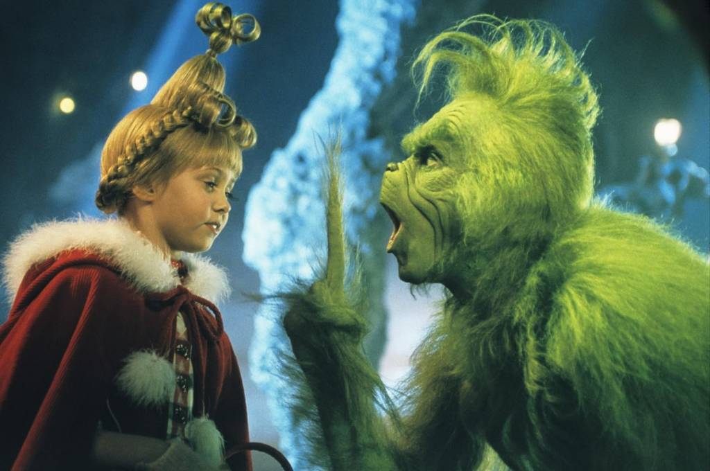 the Grinch holding a finger up at Cindy Lou Who