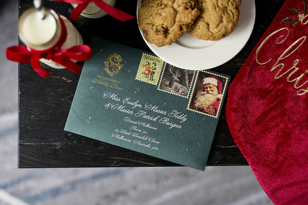 a letter from Santa surrounded by milk and cookies