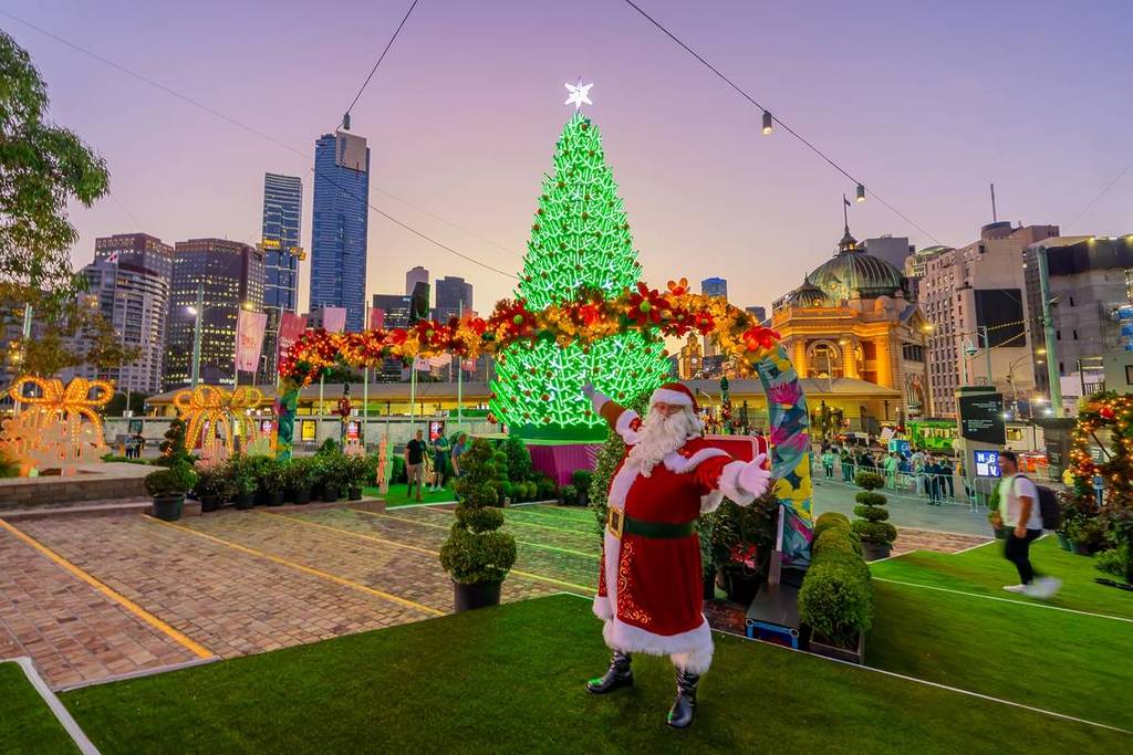 Santa in front of the Christmas tree in Fed Square