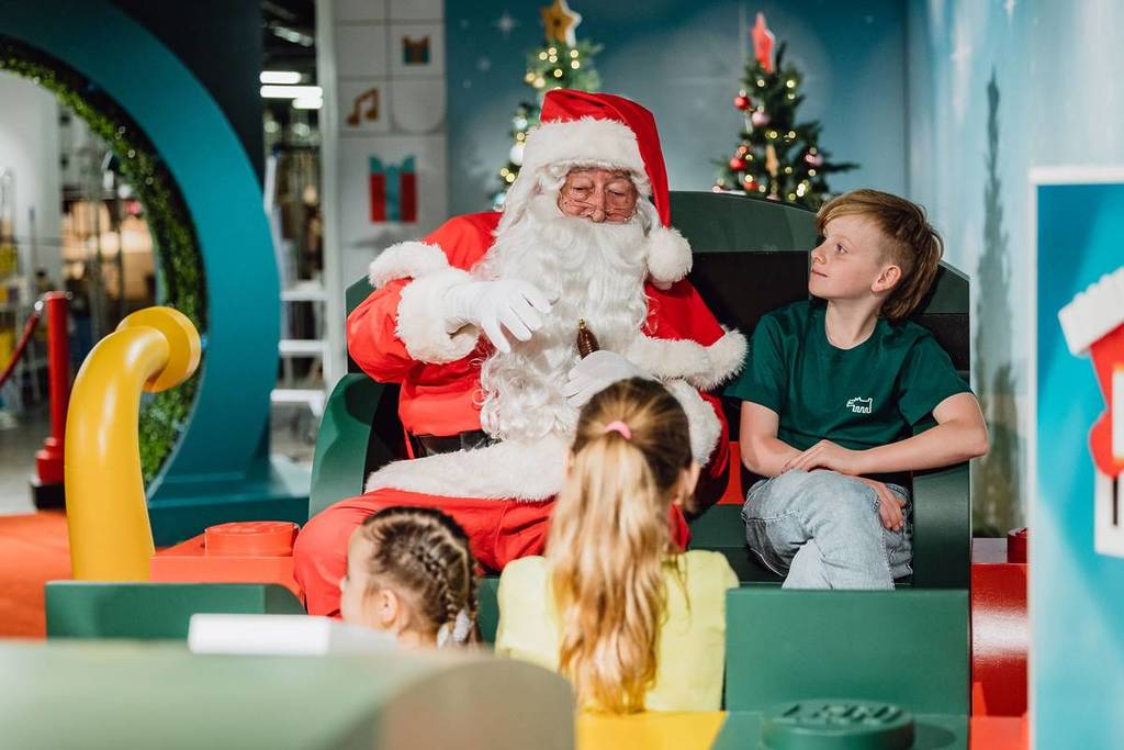 Santa sitting and talking to children