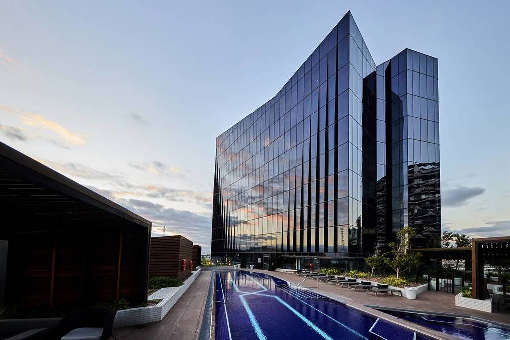 the pool at sunset on the rooftop of Vibe Hotel in Docklands