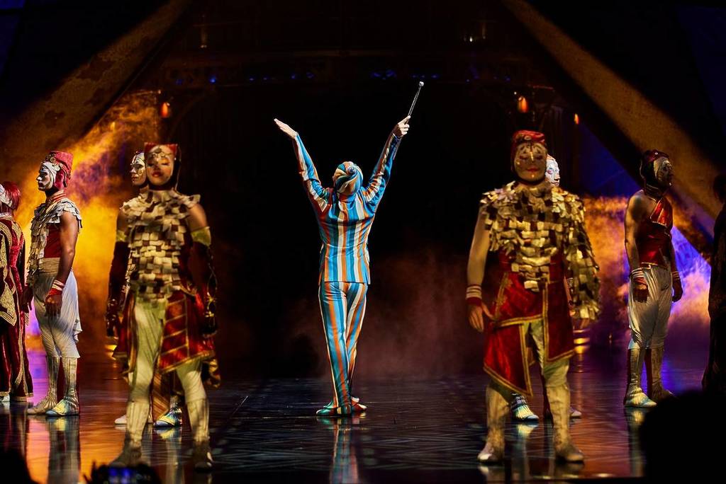 striped performer striking a pose at Cirque du Soleil
