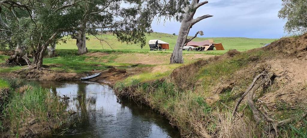 campsite next to a creek