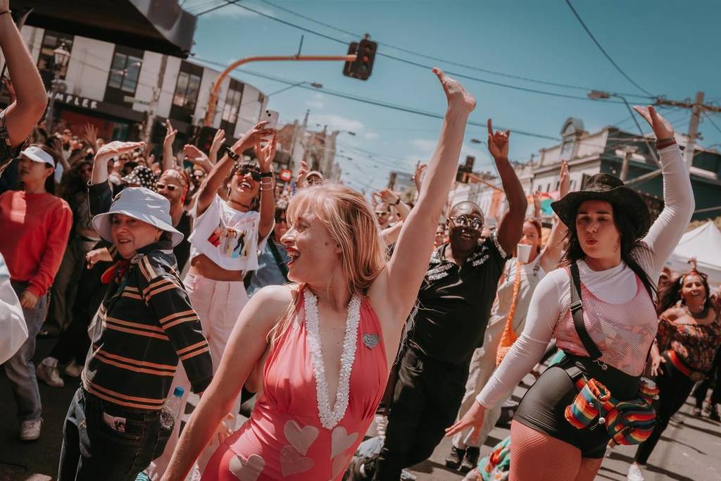 women dancing in the street on a sunny day at Victoria's Pride