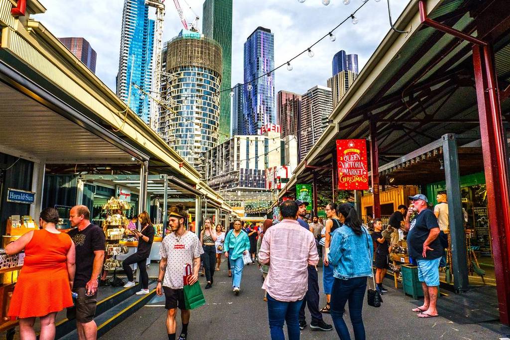 people walking down a laneway at Queen Victoria Market