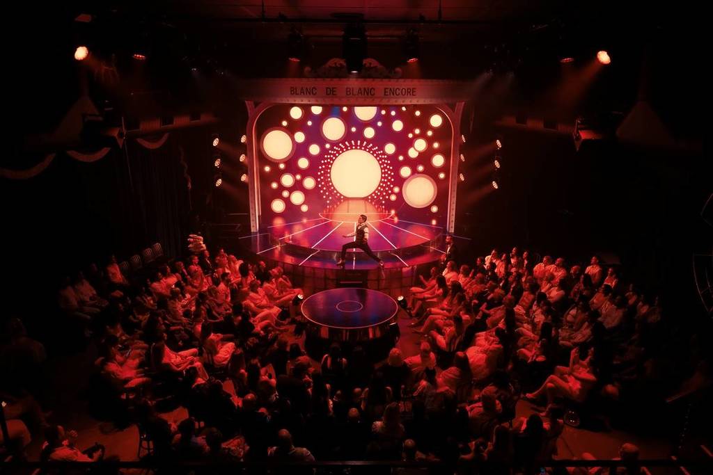 performer in front of audience at Blanc de Blanc Encore