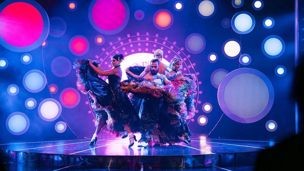 male and female dancers twirling tulle skirts