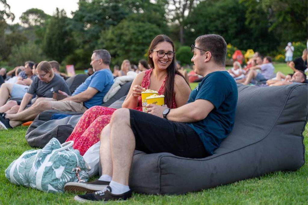 people sharing popcorn on a bean bag