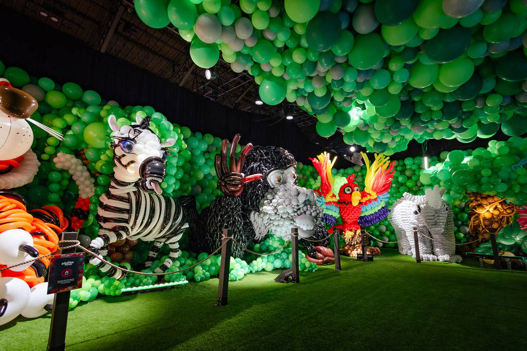 A lion, zebra, monkey, bird and elephant stand in a row, created entirely by balloons for Balloon Story.