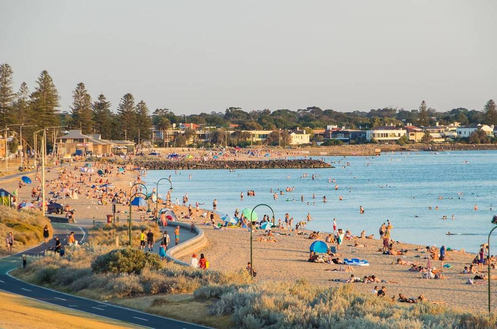 people relaxing on Elwood Beach at sunset