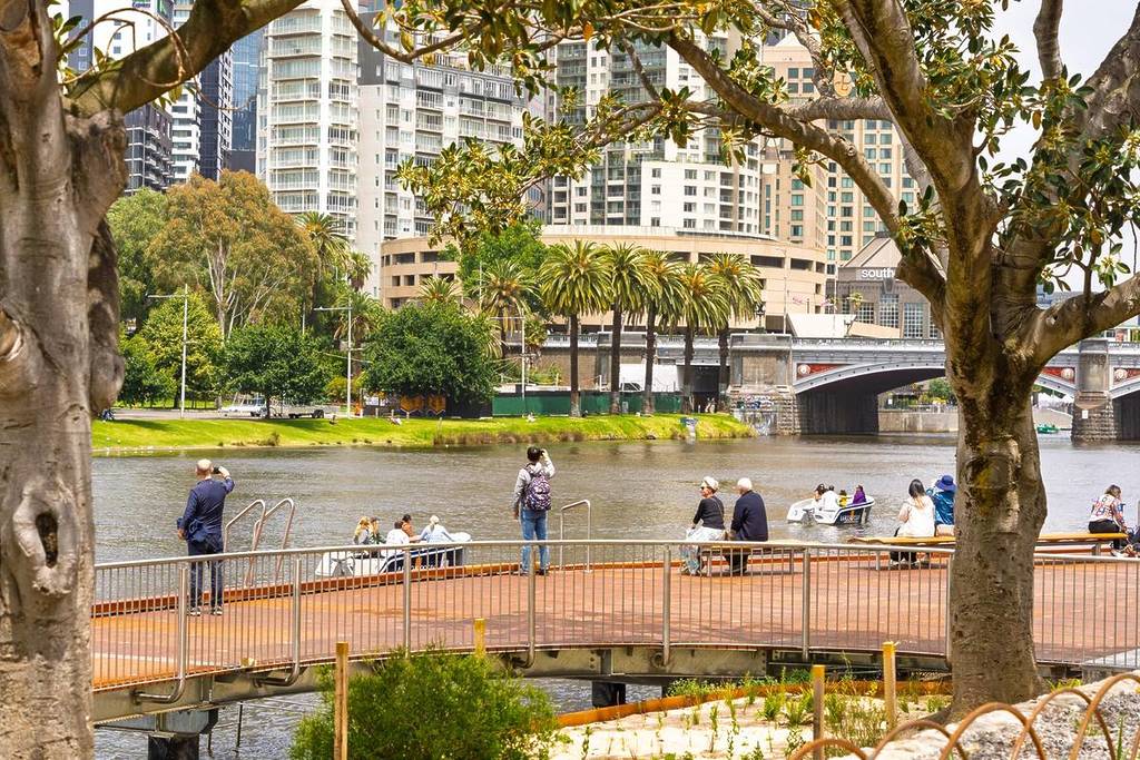 people enjoying a sunny day on the new boardwalk by the Yarra at Birrarung Marr