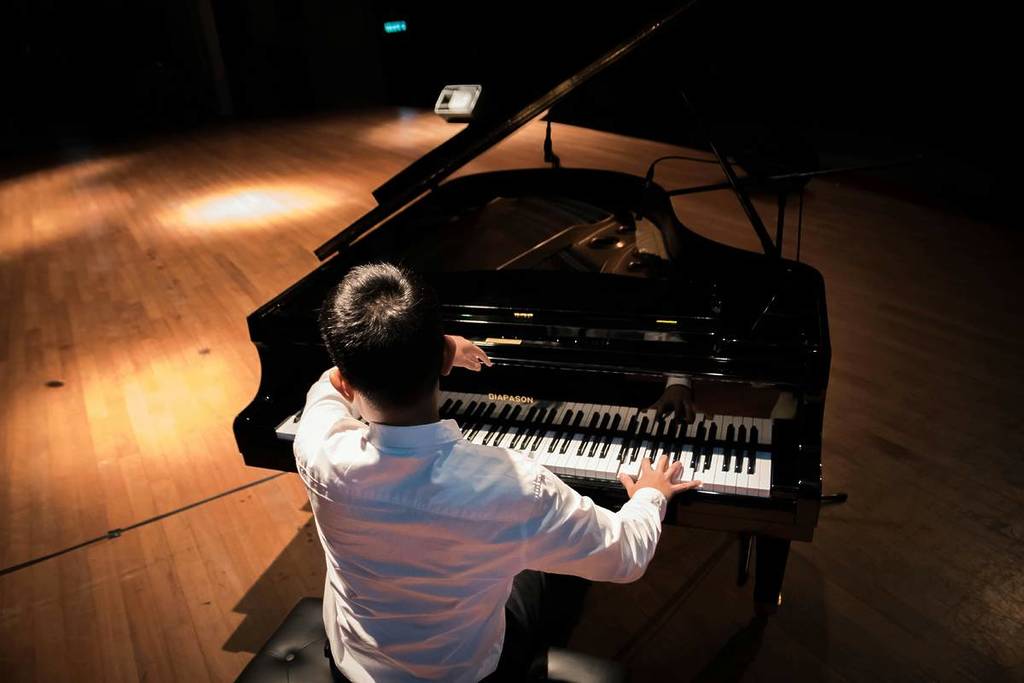 A musician playing the grand piano