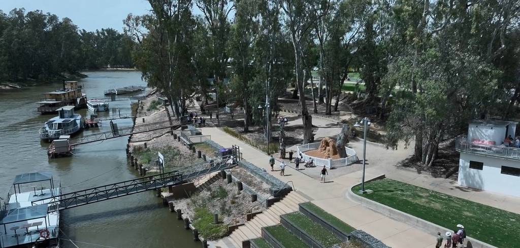 aerial view of an Alice in Wonderland sand sculpture by the Murray River in Echuca