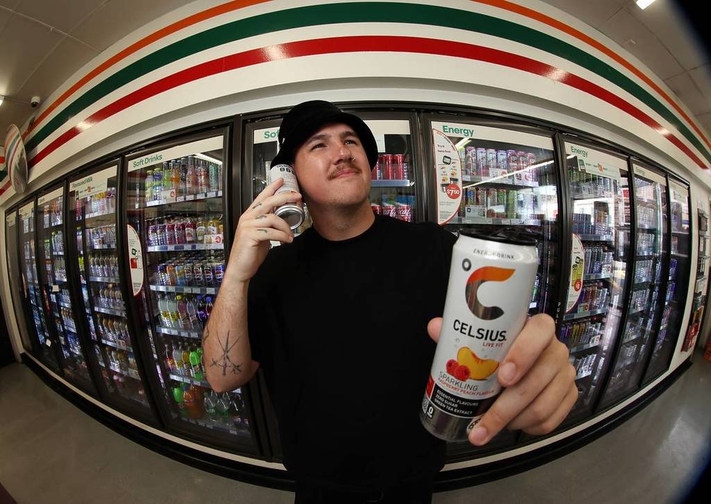Cyril at 7-Eleven holding a Celcius drink