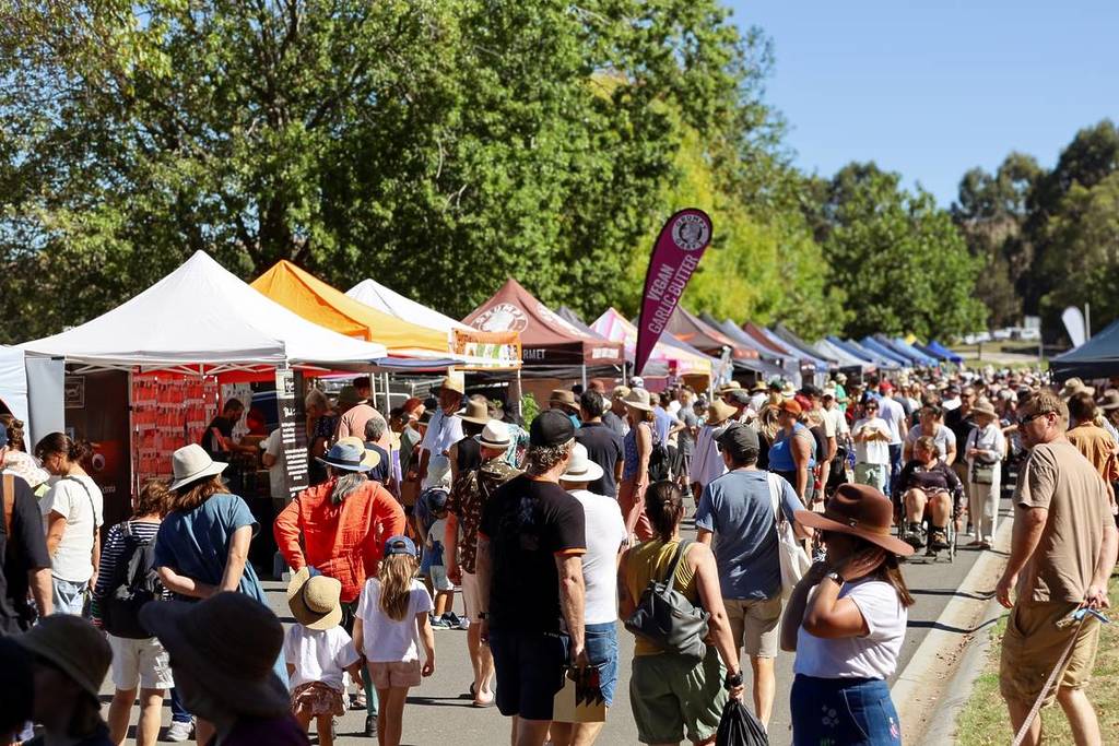 people walking in front of a line of stalls at the South Gippsland Garlic Festival