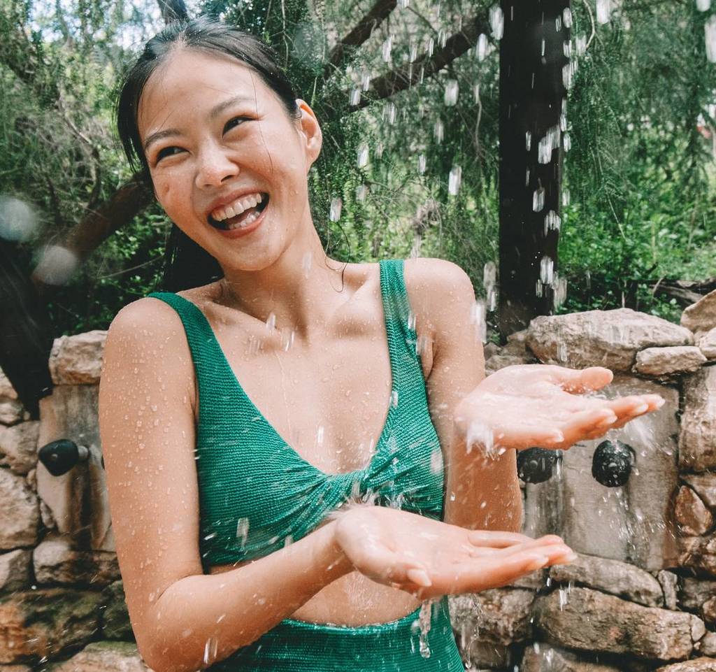 woman staying cool at Peninsula Hot Springs with an outdoor shower