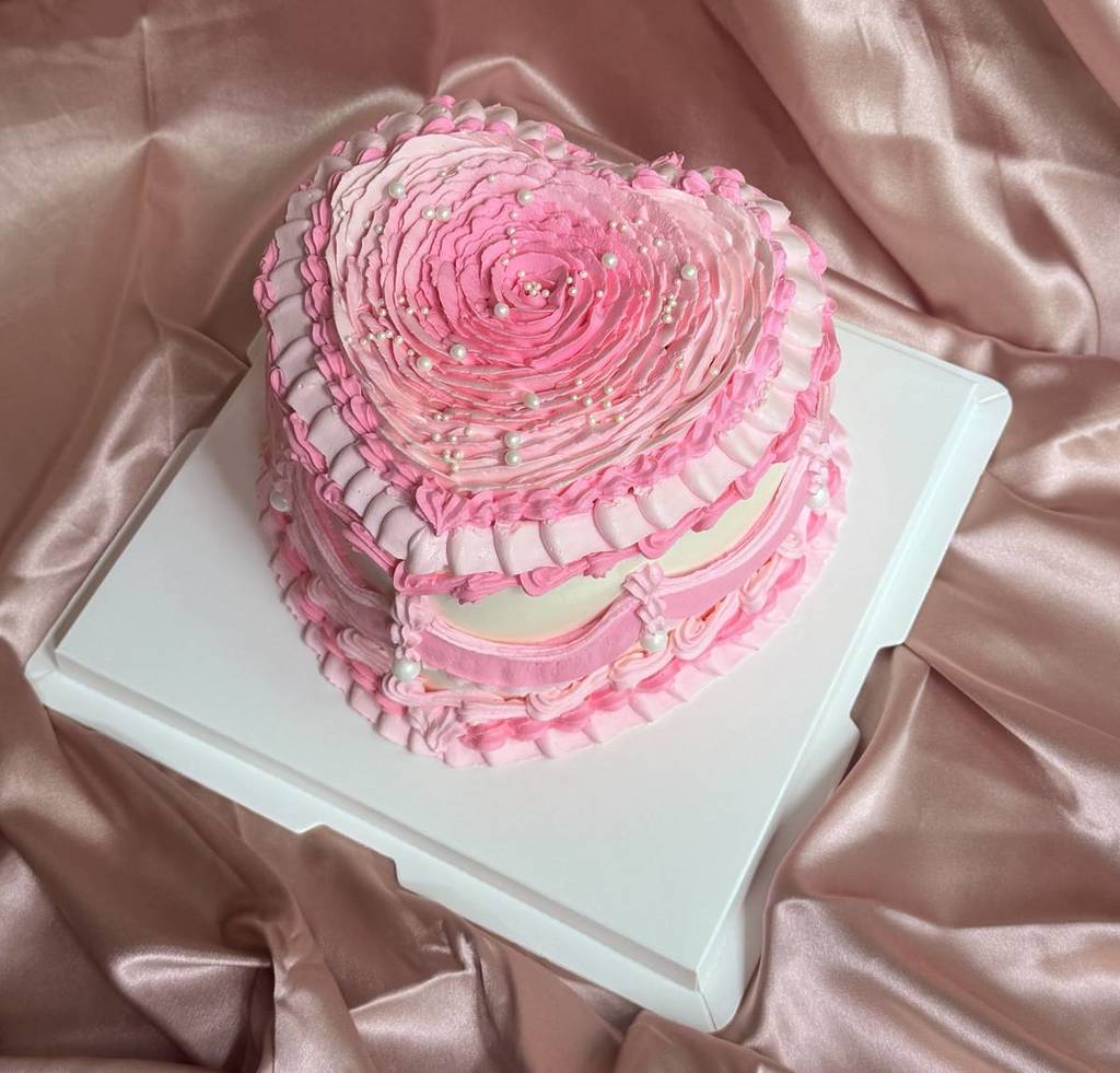 heart-shaped pink and white cake