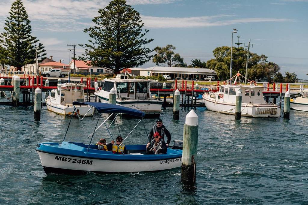 people on a boat by the jetty of Port Albert