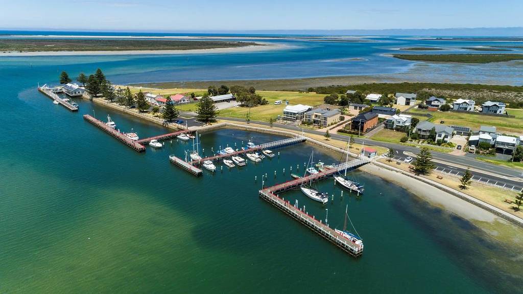 aerial view of Port Albert, showcasing the jetties, boats and coastline