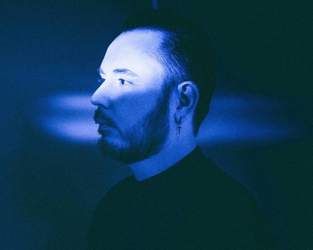 Duke Dumont's head with blue light projected over it