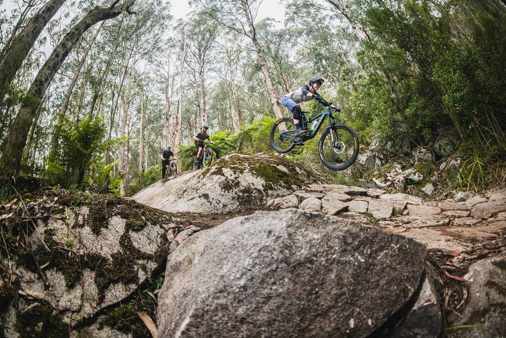 mountain bike riders zooming down rocks at Warburton Bike Park