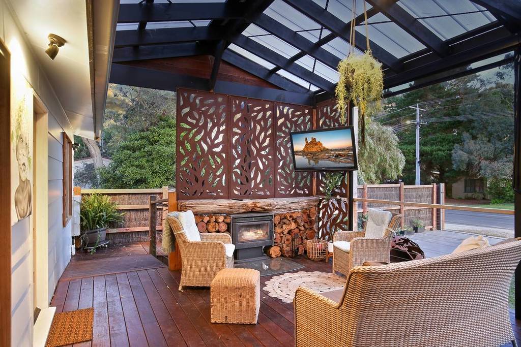 outdoor patio area with a fireplace for a house on Airbnb