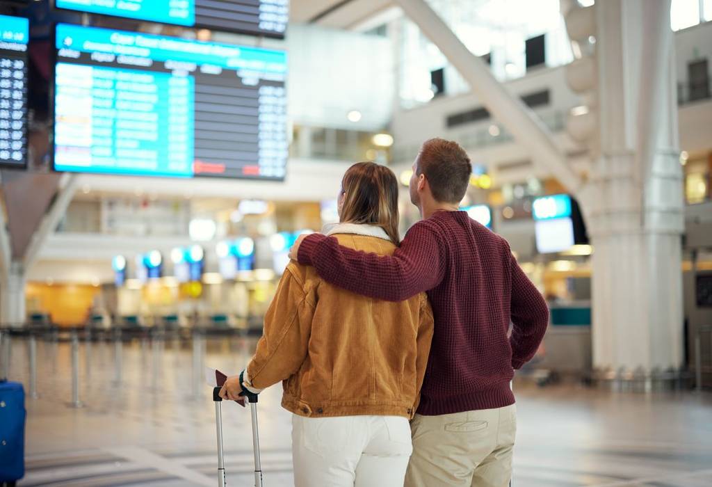 older couple checking flight times during valentines travel