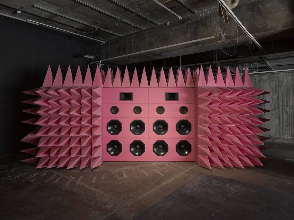 big structure that looks like a pink boom box with speakers and cones for soundproofing