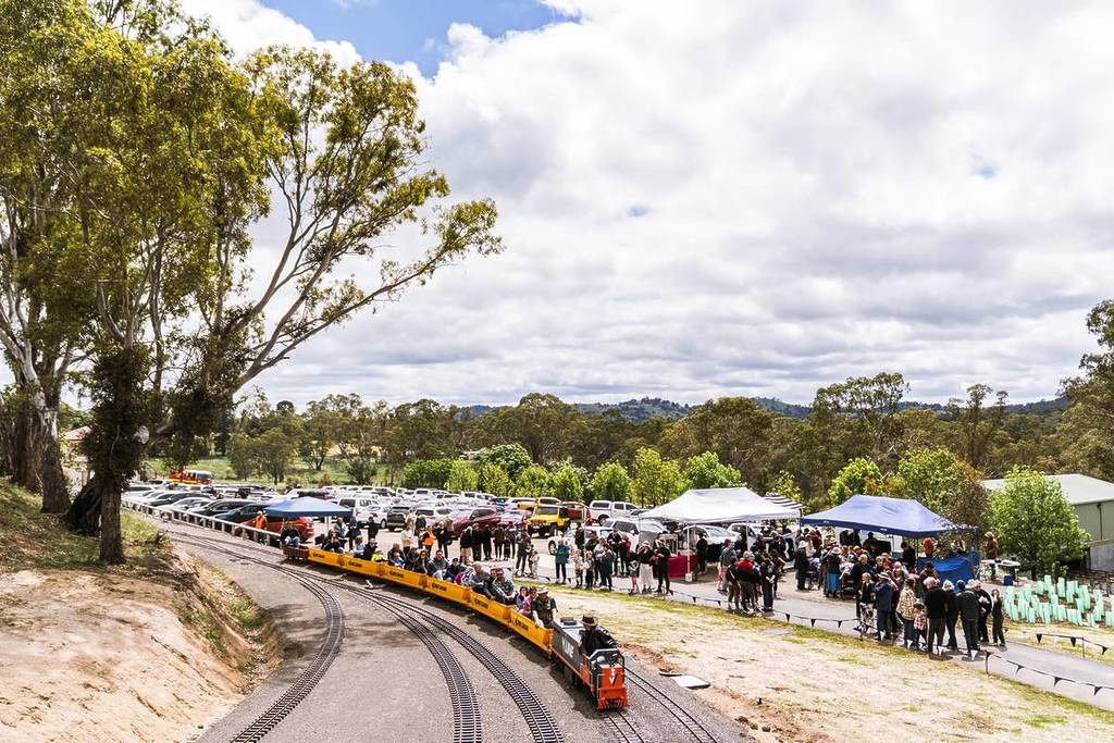 visitors riding a mini train at Victorian Miniature Railway