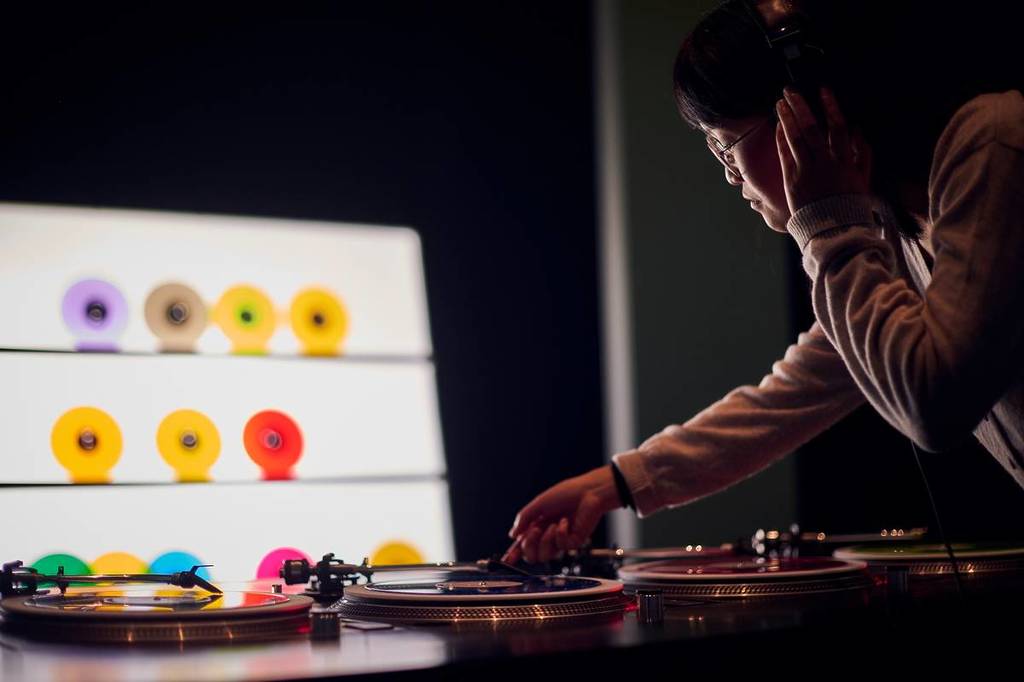 woman playing with turntable at The Vinyl Factory: Reverb exhibition at ACMI