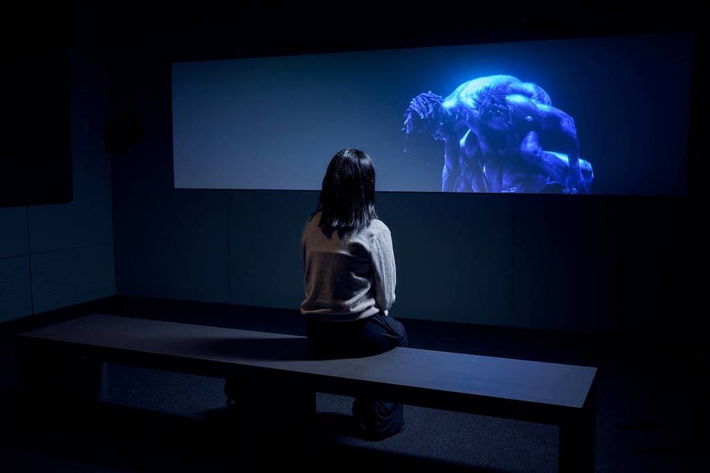 woman watching dancer on screen at ACMI vinyl exhibition