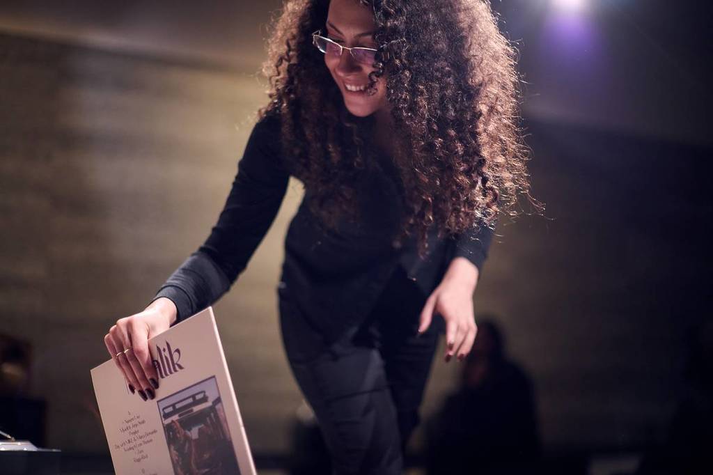 woman selecting a vinyl record to listen to